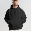 young-male-model-with-frizzy-hair-wearing-hoodie-mockup-in-minimalistic-background-scene1-078 (1) black hoodie