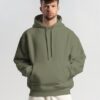 young-male-model-with-frizzy-hair-wearing-hoodie-mockup-in-minimalistic-background-scene1-078 (3) olive hoodie