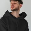 young-male-model-with-frizzy-hair-wearing-hoodie-mockup-in-minimalistic-background-scene3-075 (1) black hoodie