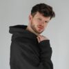 young-male-model-with-frizzy-hair-wearing-hoodie-mockup-in-minimalistic-background-scene5-073 (1) black hoodie